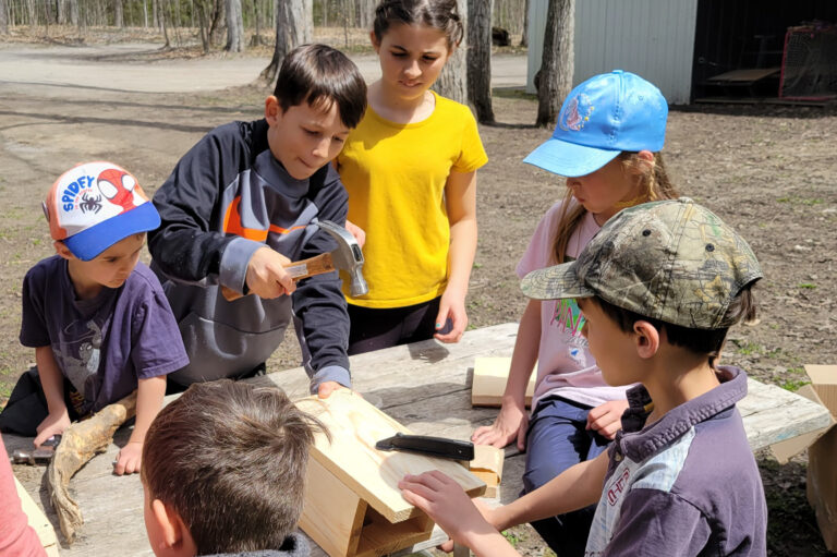 Six children working together to make a bird box